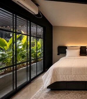 A bedroom with a large window, a bed, and a wall-mounted air conditioning unit. - BLACK ROSE (Medellín)
