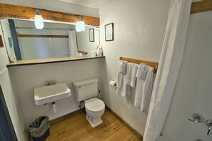 Combined shower/tub, towels, soap, shampoo - The Lodge Motel (Fort Garland)