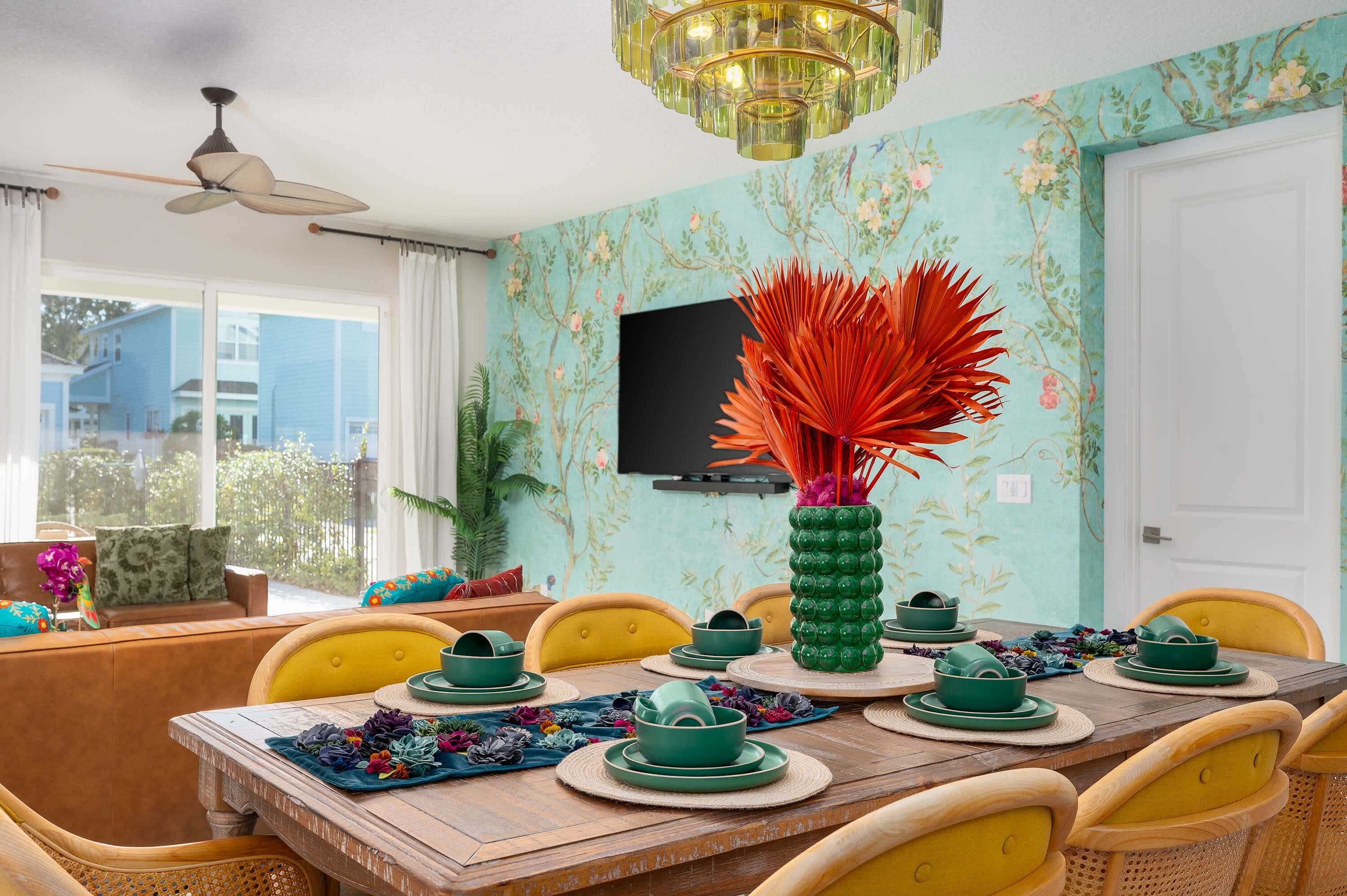 A dining area with a wooden table set for four, surrounded by yellow chairs.