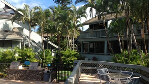 An outdoor patio with stone flooring, metal chairs, and a pool area. - KAHANA SPACIOUS 3 BEDROOM CONDO; BEACH ON SITE; EXCELLENT VIEWS (Lahaina)