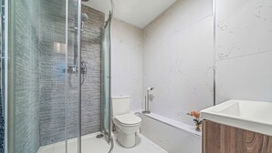 A modern bathroom with a glass-enclosed shower, a toilet, and a sink. - College Lane Apartment, Bury St Edmunds (Bury St Edmunds)