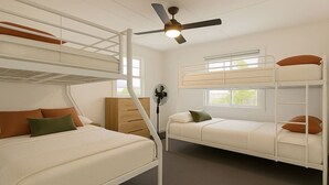 Dormitorio con literas, ventilador de techo, ventana y cómoda.