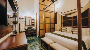 A traditional Japanese-style bedroom with tatami flooring, a low wooden bed with a canopy, and a wooden wardrobe.