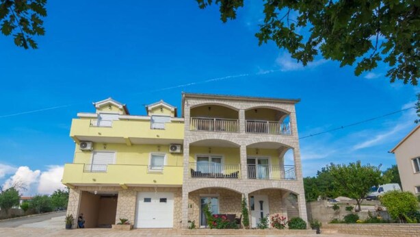 A two-story residential building with a stone facade, a flat roof, and a balcony on the upper floor. - Holiday House Balen With Swimming Pool (Benkovac)