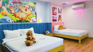 A hotel room with two beds, each with a white mattress and a colorful headboard. There are plush toys on the beds, and a neon animal sign on the wall. - Casa de Capybara (Siem Reap)