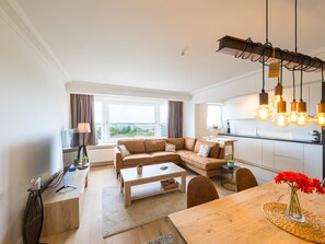 A modern apartment with a living area, dining space, and kitchen. - Apartment with 2 bedrooms and a beautiful view (Middelkerke)
