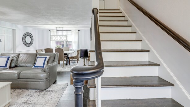 A staircase with a black handrail leading to a landing. - Close to Connecticut College & Coast Guard Academy (Quaker Hill)