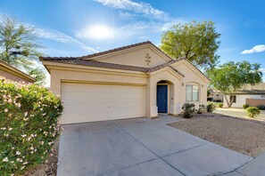 A residential house with a beige facade, a blue door, and a garage. - Hike, Golf & Relax: Desert Retreat in Cave Creek (Cave Creek)