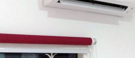 A white air conditioning unit mounted on a wall.