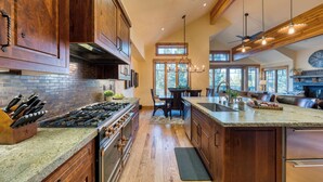 A spacious kitchen with wooden cabinets, a granite countertop, and stainless steel appliances. - Truckee Escape w/ Hot Tub, Chef’s Kitchen & Minutes to Skiing, Dining & Trails (Truckee)