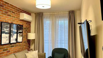 Appartement Deluxe, balcon, vue ville | Coin séjour