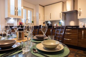 A modern kitchen with a dining area set for a meal.