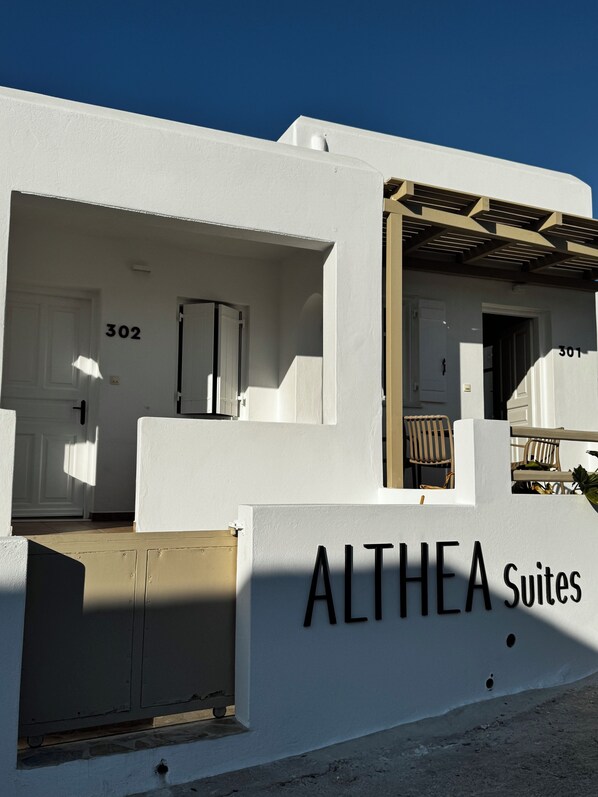 A building with the name "ALTHEA Suites" and room numbers 301 and 302.