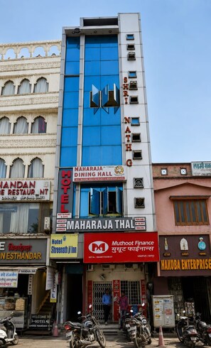 A multi-story building with various businesses including a hotel, restaurant, and finance office. - Hotel Shreenathji Inn (Udaipur)