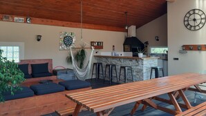 A cozy living area with a wooden bench, a hanging plant, and a kitchen counter. - Comfortable villa between the Mediterranean and the Corbières (Boutenac)