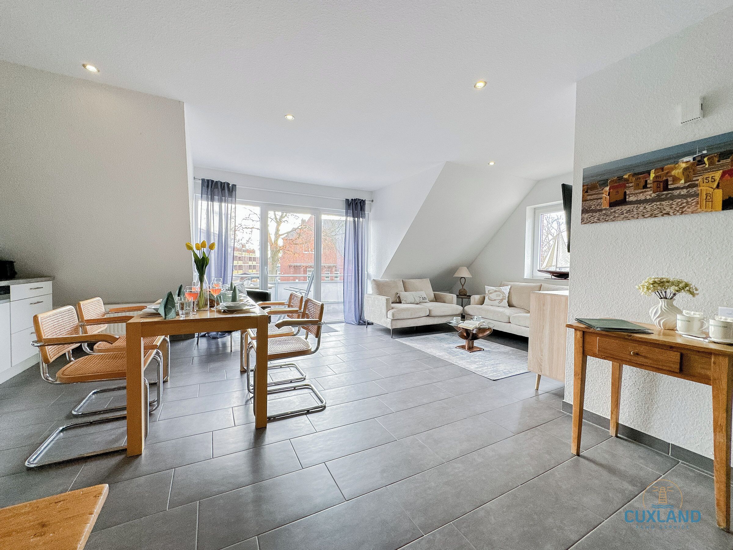 A modern living room with a dining area, featuring a sofa, chairs, a dining table, and a coffee table.