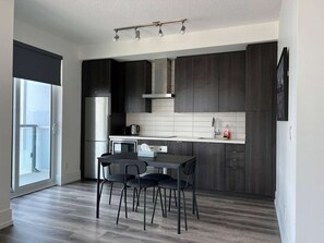Fridge, microwave, oven, stovetop - RivetStays | The Atmos City 2 Suite – 1 Bedroom Condo (Toronto)