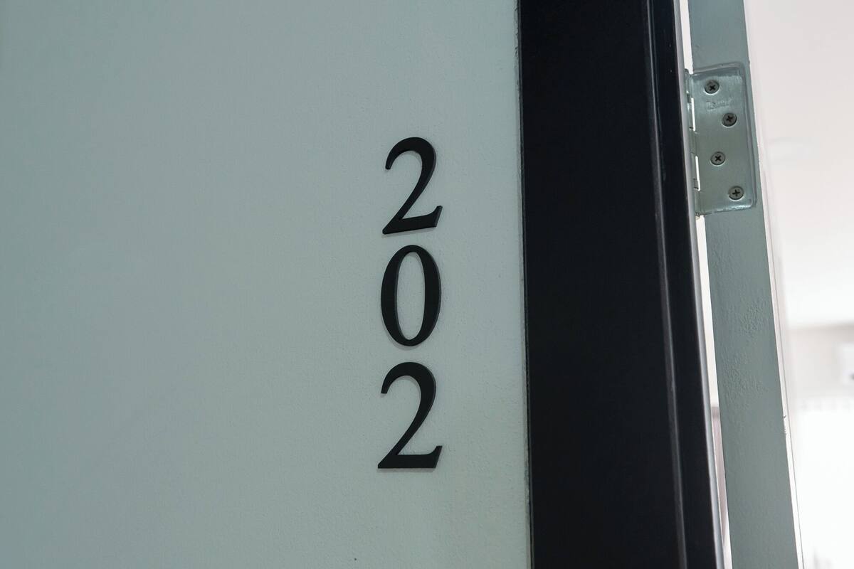 A close-up of a door with the number "202" on it.