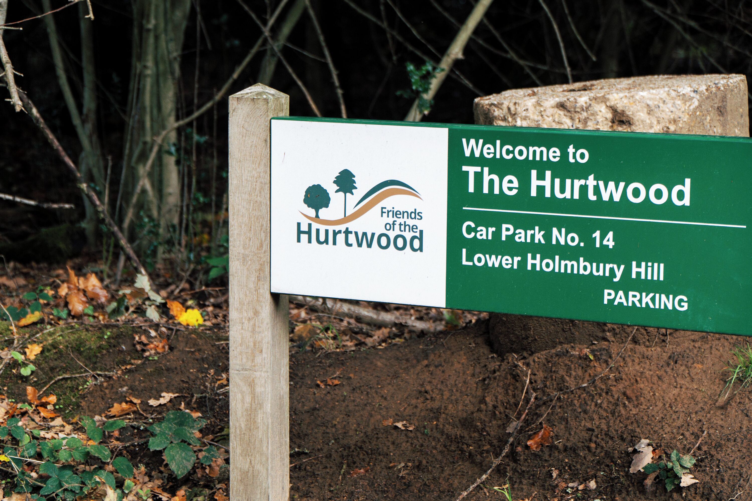 A sign welcoming visitors to The Hurtwood, indicating Car Park No. 14 and Lower Holmbury Hill.