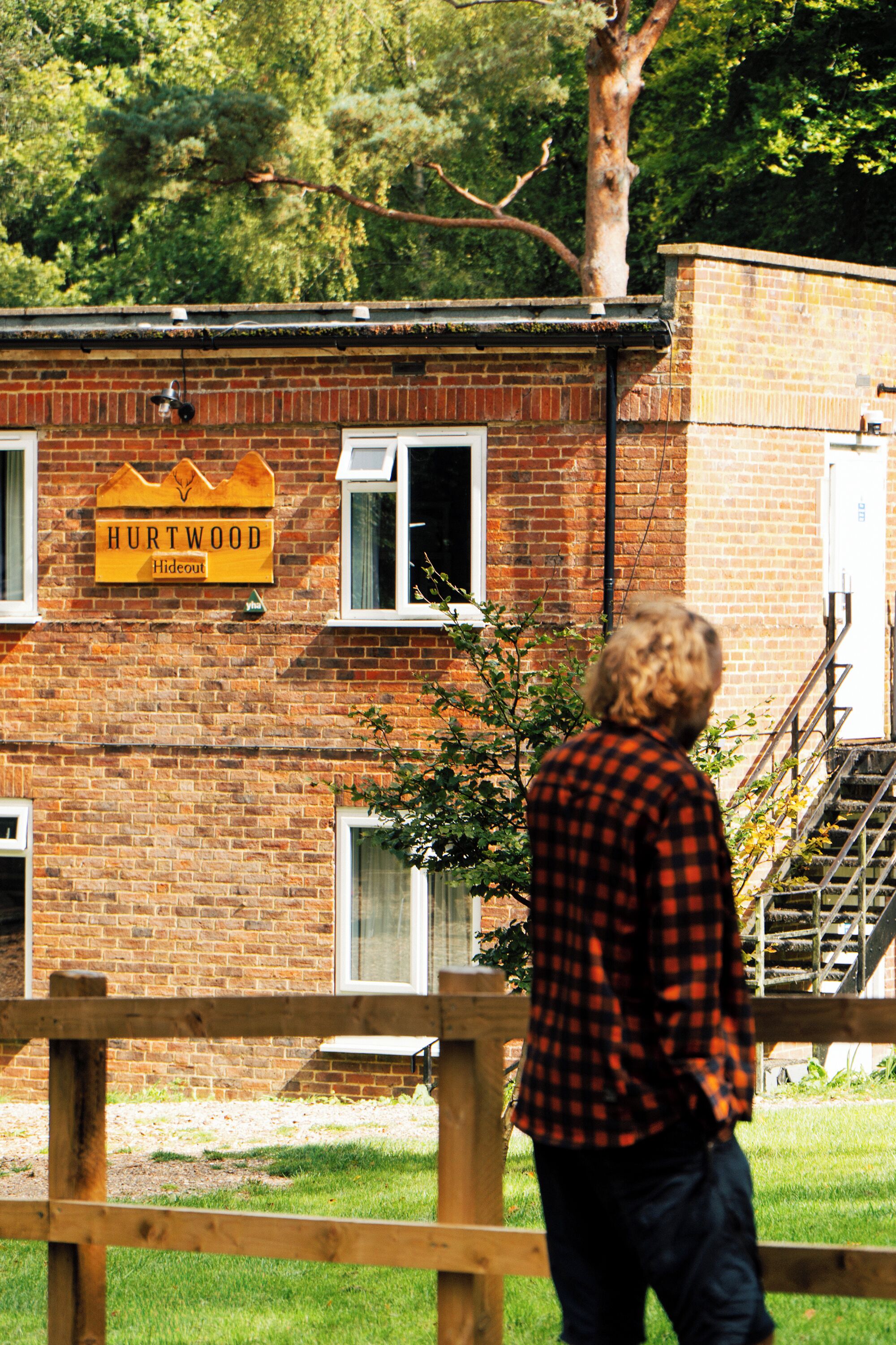 A brick building with a sign that reads "HURTWOOD Hideout."
