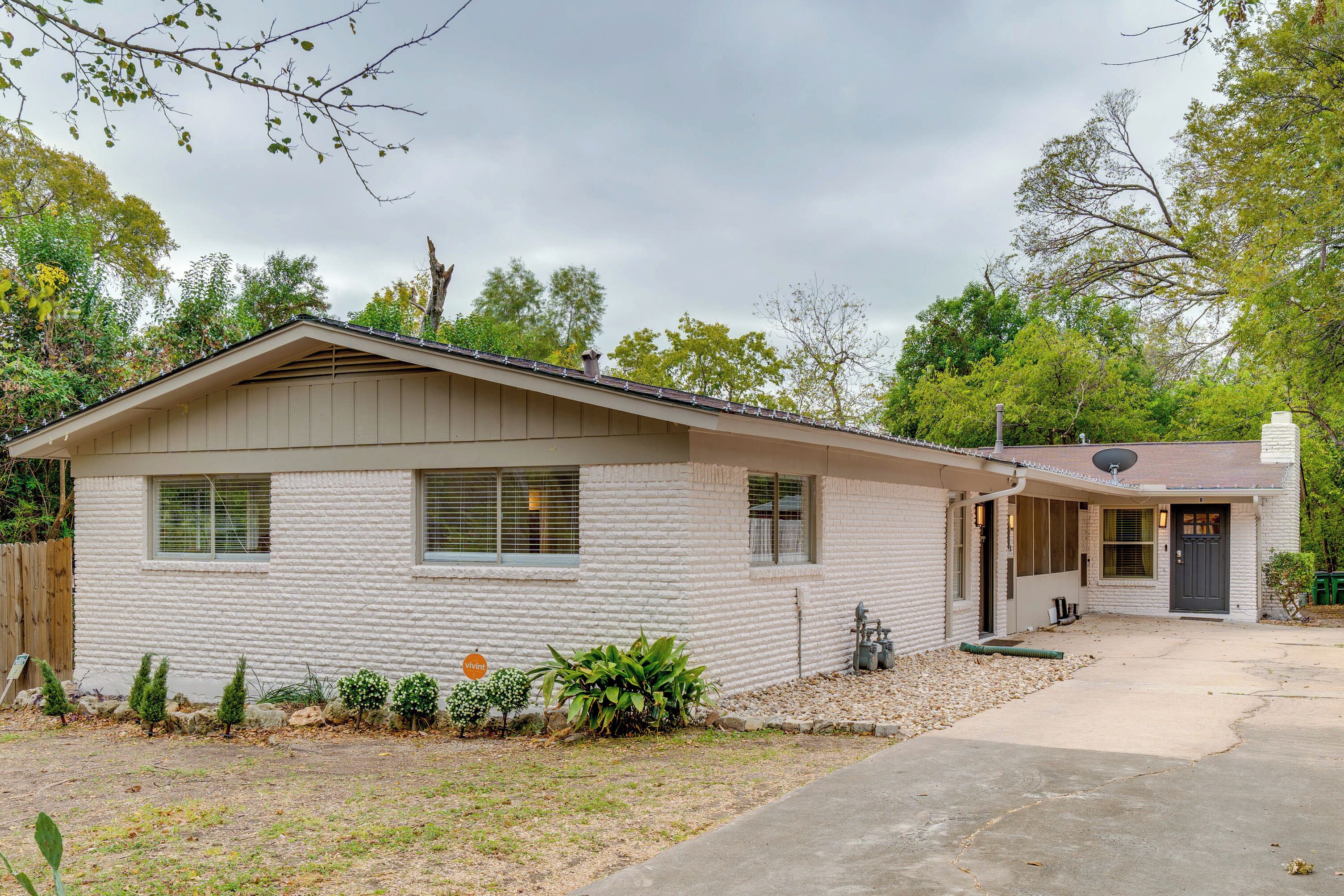 A single-story house with a front porch, a garage, and a driveway.