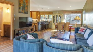 A spacious living room with a large TV, comfortable seating, a dining area, and a kitchen. - Walk to Main St Frisco: Mount Royal View (Frisco)