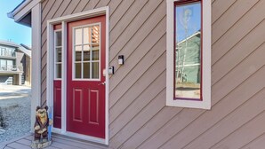 A house with a red door, a mailbox, and a small bear statue on the porch. - Walk to Main St Frisco: Mount Royal View (Frisco)