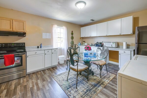 A kitchen with white cabinets, a stainless steel oven, a microwave, and a refrigerator. - Great for Gatherings! Rural Fort Valley Retreat (Fort Valley)