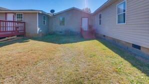 A mobile home with a red deck, a small front yard, and a clear sky. - Countryside Escape, 8 Mi to Fvsu & Main Street! (Fort Valley)