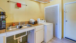 A compact kitchen with a sink, a coffee maker, and a washing machine. - Countryside Escape, 8 Mi to Fvsu & Main Street! (Fort Valley)