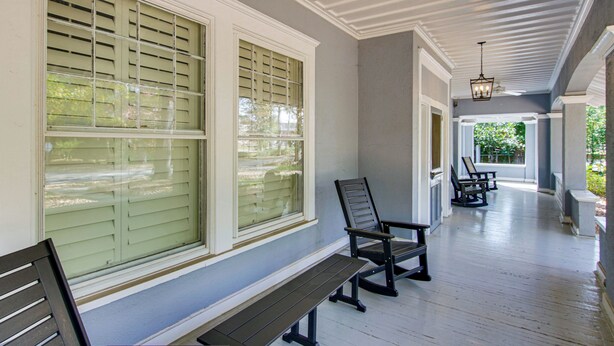 A covered porch with wooden benches and a view of the outdoors. - Walk to Coker University & Dtwn! Home w/ Game Room (Hartsville)