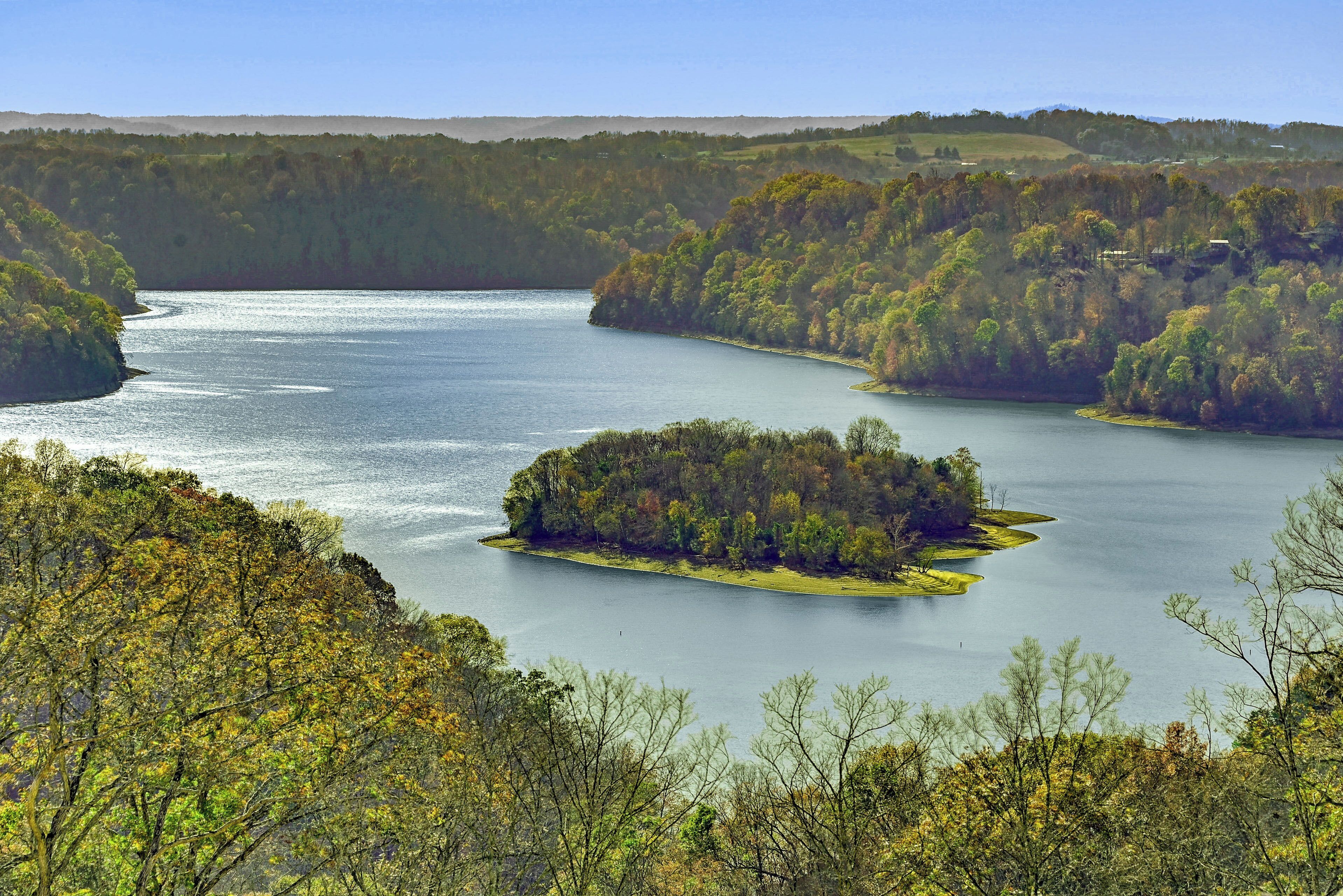 A lake surrounded by forested hills.