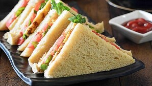 A plate of sandwiches with a side of ketchup. - Hotel Devki Inn (Gorakhpur)