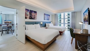 A modern hotel room with two beds, a desk, and a dining area. - CIRC Hotel By Hosteeva (Hollywood)