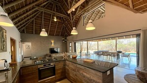 A modern kitchen with a large island, built-in appliances, and pendant lighting. - Luxury Bush villa for rent in Hoedspruit, near Kruger National Park (Hoedspruit)