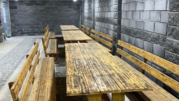 A row of wooden benches against a stone wall in a covered outdoor area. - 3-bedroom villa in perfect Getamej with pool and coolest view (Ashtarak)