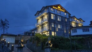 A multi-story building with balconies and a sign reading "King Castle."