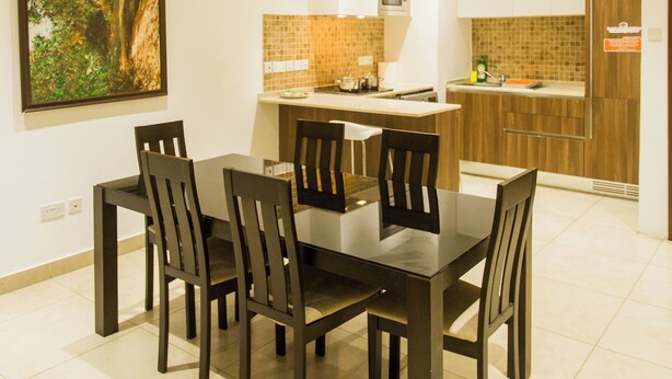 A modern kitchen with a dining area. - Spacious Two Bedroom Luxury at Avant Garde (Accra)