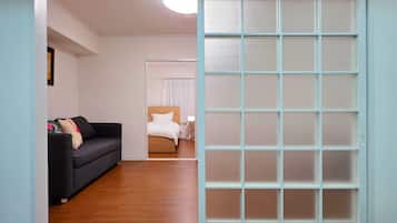 Family Triple Room | Living area | 32-inch flat-screen TV with cable channels