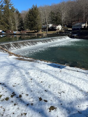 A snow-covered landscape with a dam and a river. - Cozy, PRIVATE, 4-bedroom cabin on 40 acres. (Markleton)