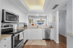Fridge, microwave, oven, stovetop - Beachfront Loggerhead Cay 264 —Sunrise & Gulf Water Views, heated Pool, Pickleball & Tennis, Bikes + Beach Gear. (Sanibel Island)