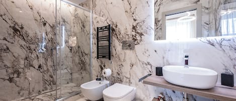 Regadera, secadora de cabello, bidet, toallas