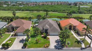 A residential area with houses, a golf course, and a body of water. - Poolside Bliss/fenced yard/water views/golf/pickleball/pets/tennis/sun & fun (Laguna Vista)