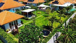 A residential area with multiple houses featuring orange tiled roofs and solar panels. - TropicalFamilyVilla w Pool&Garden ML103 (Hua Hin)