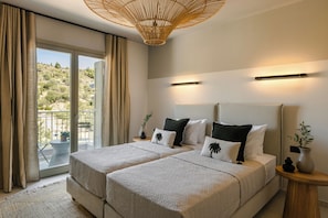 A double bed with a textured blanket, a bedside table with a vase, and a view of a balcony with a table and chairs. - Assos Reverie Villa (9GGR+RXG Erisos, Greece)