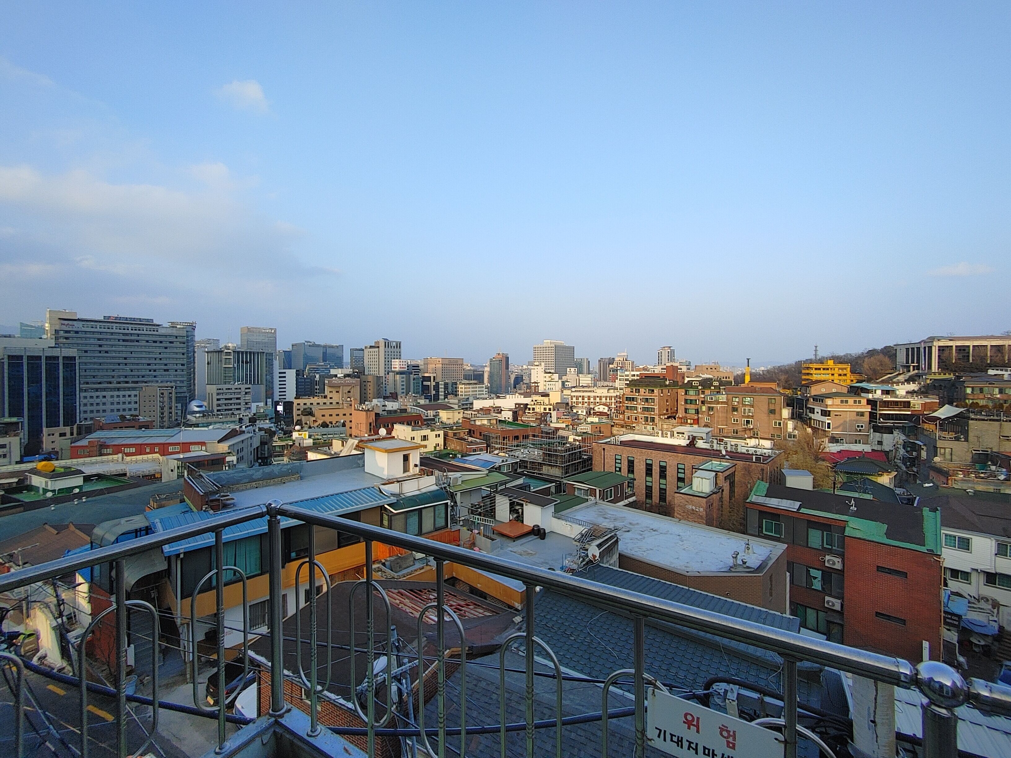 A cityscape with a variety of building types, including modern high-rises and older structures.