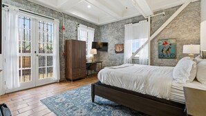 A bedroom with a bed, a desk, a wardrobe, and a television. - First floor Cozy king room w/ Wine Country Charm (Santa Rosa)