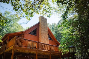 A cabin with a wooden deck and a chimney. - Goat Run Retreat | Hocking Hills, Hot Tub, Sauna (Logan)