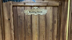 A wooden door with a sign that reads "Booking Room." - Old City Butik Hotel (Tashkent)
