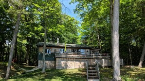 A cabin with a deck, surrounded by trees. - Oars n Smores
A place to call yours. (Georgian Bay)